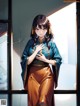 A woman in a blue kimono standing in front of a window.