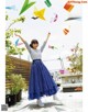 A woman in a striped shirt and a blue skirt is flying paper airplanes.