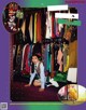 A woman sitting on the floor in front of a closet full of clothes.