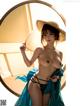 A woman in a blue dress and a straw hat posing for a picture.