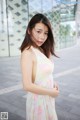 A woman in a colorful dress posing for a picture.